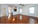 Bright living room featuring hardwood floors, a modern ceiling fan, and natural light from two windows at 5216 Crystal Lakes Dr, Rock Hill, SC 29732