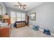 This bedroom has a large window, soft carpet, and an overhead fan at 5425 Closeburn Rd # 105, Charlotte, NC 28210