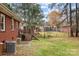 Large backyard featuring a brick house, a cozy deck, and lush green space for entertaining at 616 W D Ave, Salisbury, NC 28144