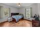 Bright bedroom with hardwood floors and natural light from two windows at 616 W D Ave, Salisbury, NC 28144