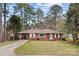 Inviting single-story brick home featuring a covered carport and a well-maintained front lawn at 616 W D Ave, Salisbury, NC 28144