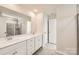 Bathroom featuring double sinks, a large mirror, and a shower with glass doors at 6265 Fairfax Ct, Maiden, NC 28650