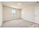 Neutral carpeted bedroom featuring a window and closet space at 6265 Fairfax Ct, Maiden, NC 28650