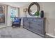 Well-decorated bedroom featuring a dresser with a decorative mirror, chair, and natural light from a window at 6265 Fairfax Ct, Maiden, NC 28650
