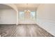Dining room featuring elegant wainscoting, modern lighting, and plenty of natural light from the windows at 6265 Fairfax Ct, Maiden, NC 28650