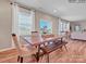 Dining area with natural light, table with chairs and bench, open to living area at 6265 Fairfax Ct, Maiden, NC 28650