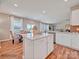 Spacious kitchen with island, white cabinets, stainless steel appliances and open-concept layout at 6265 Fairfax Ct, Maiden, NC 28650