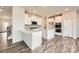 Modern kitchen with white cabinets, stainless steel appliances, and an island with a breakfast bar at 6265 Fairfax Ct, Maiden, NC 28650