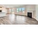 Bright living room showcasing hardwood floors, a cozy fireplace, and sliding glass doors to the backyard at 6265 Fairfax Ct, Maiden, NC 28650