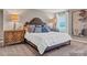 Well-lit main bedroom featuring a plush bed, bedside tables, and natural light from a window at 6265 Fairfax Ct, Maiden, NC 28650