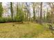 Serene backyard with a lush lawn and surrounding mature trees, offering a private outdoor space at 906 Forest Dr, Lancaster, SC 29720