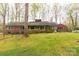 Brick house boasts a spacious backyard with mature trees at 906 Forest Dr, Lancaster, SC 29720