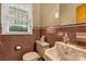 Vintage bathroom featuring a tan toilet and sink with coordinated tile and fixtures at 906 Forest Dr, Lancaster, SC 29720