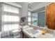 Bright bathroom featuring a glass-enclosed shower, vanity with sink, and classic black and white floor tiles at 906 Forest Dr, Lancaster, SC 29720