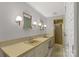 Bathroom featuring double sinks, custom mirrors, and a glass-enclosed shower at 906 Forest Dr, Lancaster, SC 29720