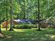 Charming single-story brick home nestled among mature trees on a lush green lawn at 906 Forest Dr, Lancaster, SC 29720