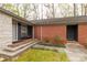 Exterior view of the front entrance featuring a brick facade, cozy bench, and a well-maintained yard at 906 Forest Dr, Lancaster, SC 29720