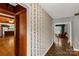 Entry hallway features hardwood floors and decorative wallpaper at 906 Forest Dr, Lancaster, SC 29720