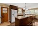 Charming kitchen with dark wood cabinetry, kitchen island with cooktop, and stainless steel appliances at 906 Forest Dr, Lancaster, SC 29720