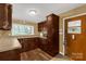 This kitchen boasts dark wood cabinets, sleek countertops, and modern appliances at 906 Forest Dr, Lancaster, SC 29720