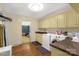 Well-lit laundry room with modern washer and dryer, sink, and ample cabinet space at 906 Forest Dr, Lancaster, SC 29720