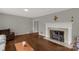 Bright living room features a white mantel fireplace and hardwood floors at 906 Forest Dr, Lancaster, SC 29720