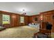 A living room with wood paneling, carpet, lots of light, and views of the outdoors at 906 Forest Dr, Lancaster, SC 29720