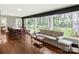 Living room features hardwood floors, a sofa and scenic backyard views at 906 Forest Dr, Lancaster, SC 29720