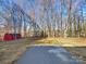 Expansive backyard with a shed surrounded by tall trees for privacy at 1021 Oakridge Farm Hwy, Mooresville, NC 28115