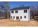 The back of the house showcases large windows and a wood deck overlooking the property at 119 Ethel Dr, Stanley, NC 28164