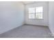 Neutral bedroom with a large window and plush carpeting at 119 Ethel Dr, Stanley, NC 28164