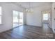 A chandelier hangs above a spacious dining area, illuminated by natural light streaming through the sliding glass doors at 119 Ethel Dr, Stanley, NC 28164