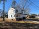 A side view of a two-story, newly constructed home with white siding and an attached garage at 119 Ethel Dr, Stanley, NC 28164