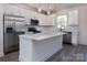Modern kitchen featuring stainless steel appliances, a center island, and white cabinetry at 119 Ethel Dr, Stanley, NC 28164