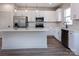 Bright kitchen with stainless steel appliances, subway tile backsplash, and a center island at 119 Ethel Dr, Stanley, NC 28164