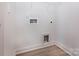 Compact laundry room with essential hookups and sleek vinyl flooring at 119 Ethel Dr, Stanley, NC 28164