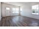 Bright living room featuring hardwood floors and large windows providing ample natural light at 119 Ethel Dr, Stanley, NC 28164