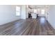 Open-concept design showcasing the living room with hardwood floors flowing into the modern kitchen at 119 Ethel Dr, Stanley, NC 28164