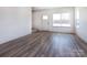 The living room features hardwood floors, a front door, and a large window at 119 Ethel Dr, Stanley, NC 28164