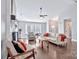 Cozy living room with hardwood floors, fireplace, a ceiling fan, and lots of natural light at 13015 Greycrest Dr, Charlotte, NC 28278