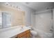 Bright bathroom featuring vanity, toilet, shower and large mirror at 151 Kallie Loop, Mooresville, NC 28117