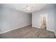 Large bedroom featuring wood-look flooring, a trey ceiling and adjoining bathroom at 151 Kallie Loop, Mooresville, NC 28117