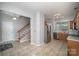 A transitional kitchen features stainless steel appliances, tile backsplash, tile flooring, and natural wood cabinets at 151 Kallie Loop, Mooresville, NC 28117