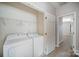 This is a laundry room with a washer and dryer, shelving, and neutral walls and flooring at 151 Kallie Loop, Mooresville, NC 28117