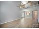Open floor plan living room with a ceiling fan, wood look flooring, natural light, and a loft at 151 Kallie Loop, Mooresville, NC 28117