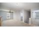 Upstairs loft area with neutral carpet and ceiling fan at 151 Kallie Loop, Mooresville, NC 28117