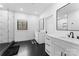 Modern bathroom featuring dual sinks, black hardware, and a glass enclosed shower with custom tiling at 1575 Shinnville Rd, Cleveland, NC 27013