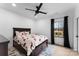 A charming bedroom with a ceiling fan, stylish bedding, and large window with natural light at 1575 Shinnville Rd, Cleveland, NC 27013