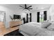 Bright bedroom features a large bed, light wood floors and dresser, and an abundance of natural light at 1575 Shinnville Rd, Cleveland, NC 27013