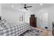 Comfortable bedroom with patterned bedding, a ceiling fan, and a classic wooden dresser at 1575 Shinnville Rd, Cleveland, NC 27013